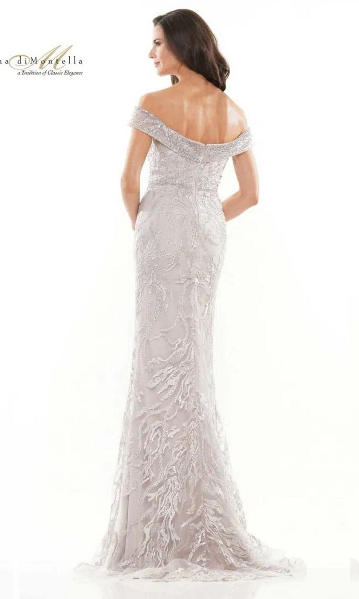 A woman showcases the Long Formal Dress: Rina Di Montella RD2713, an off-the-shoulder, floor-length embellished gown with intricate embroidery, seen from the back against a plain white background.